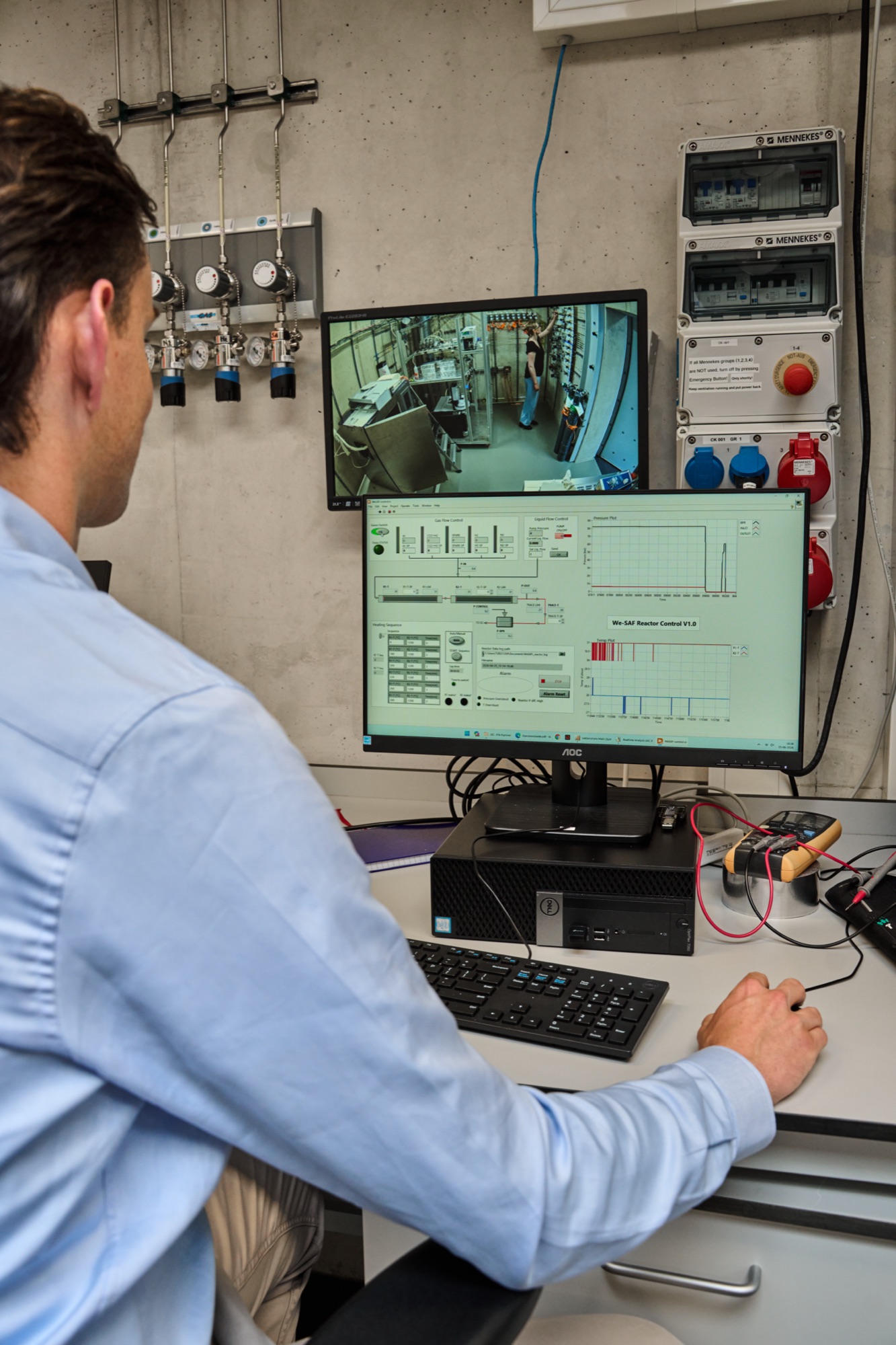 Engineer reviewing catalyst optimisation data at the control station